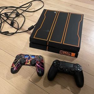 PlayStation 4 with 2 controllers and 5 PS4 games.